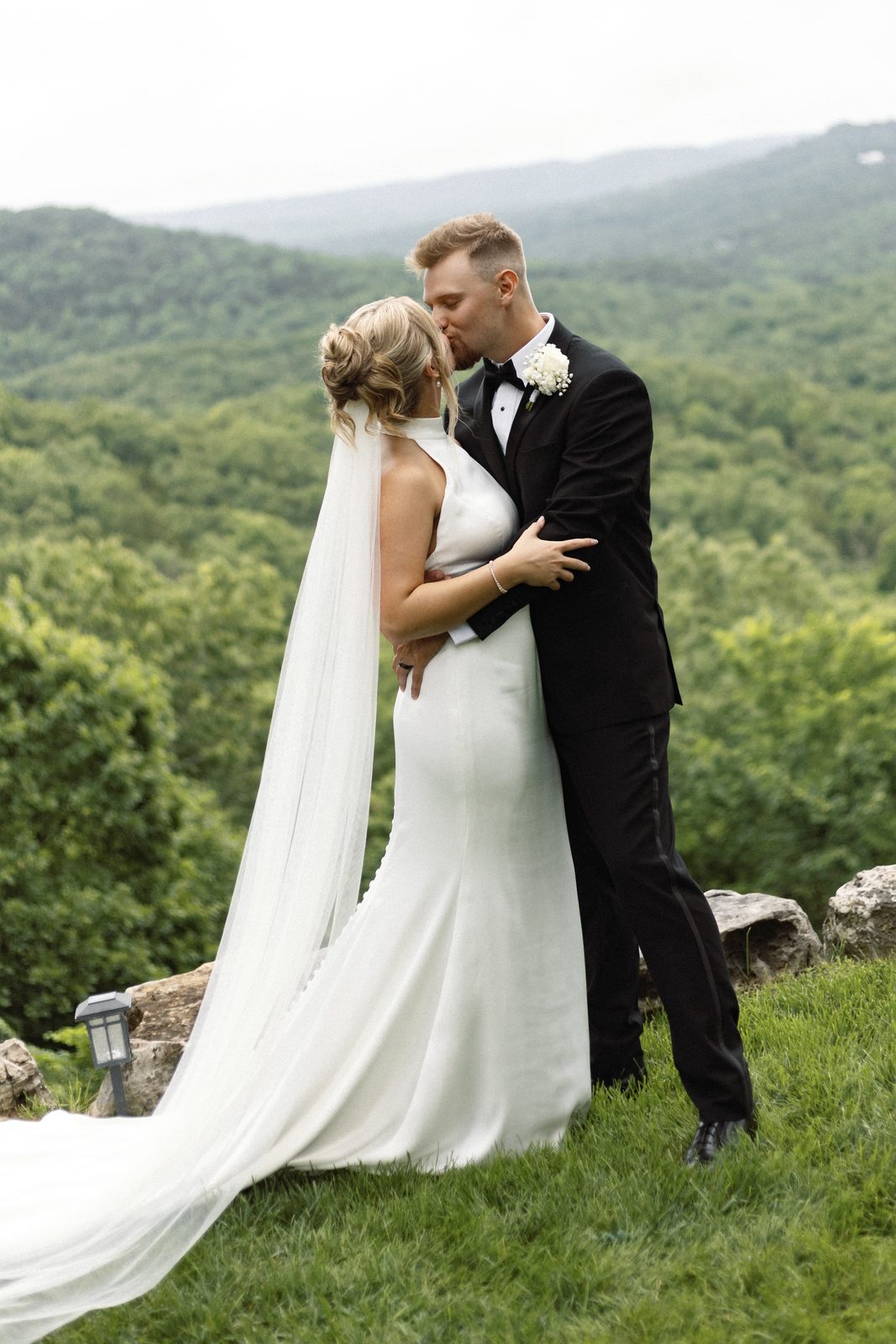 Posed portrait of the bride and groom on a Missouri hillside