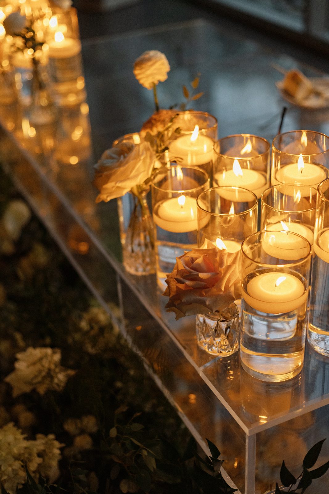 Candlelit reception details inside the Greenhouse Two Rivers glasshouse